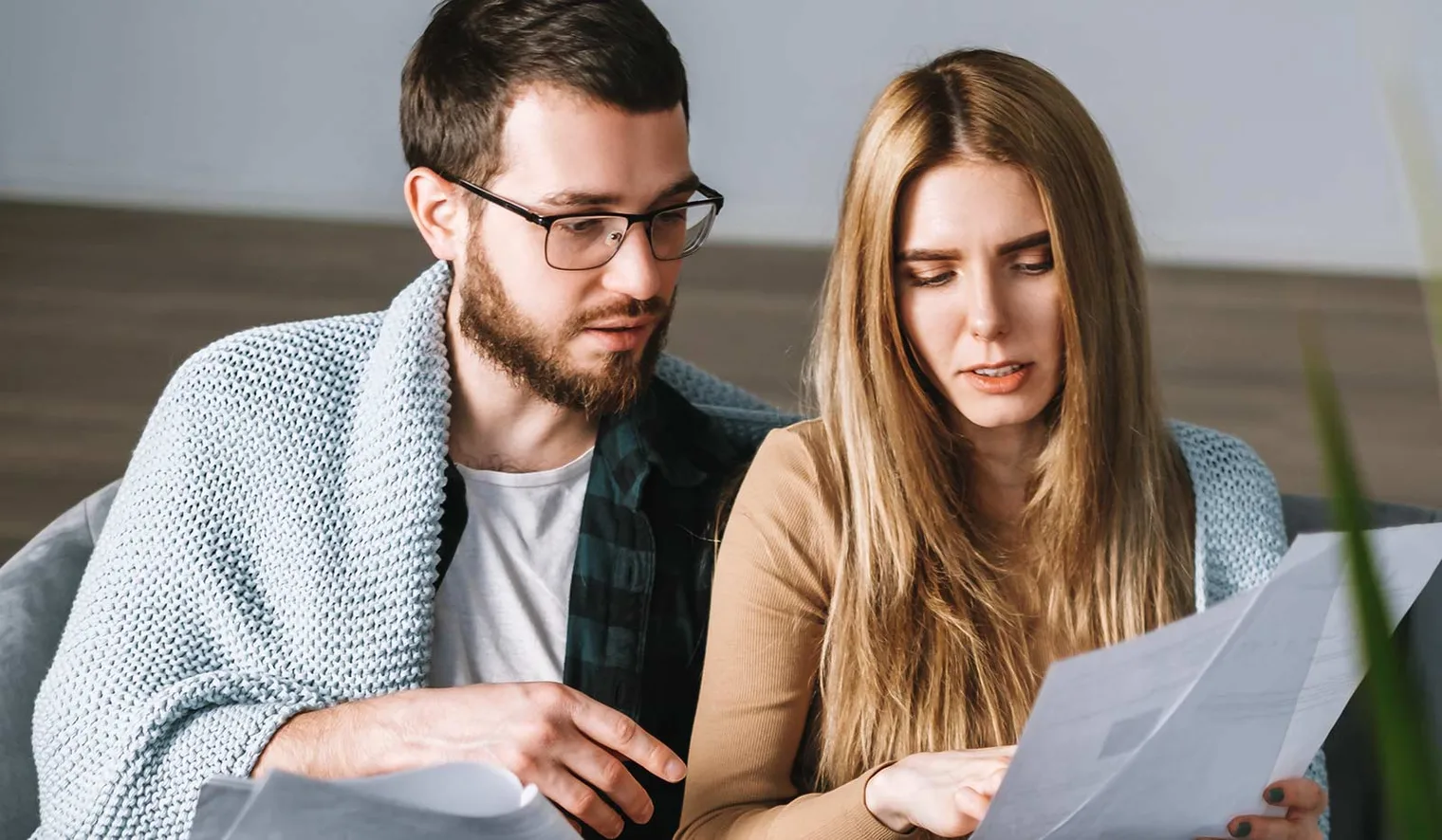 Two people sitting together looking through paperwork
