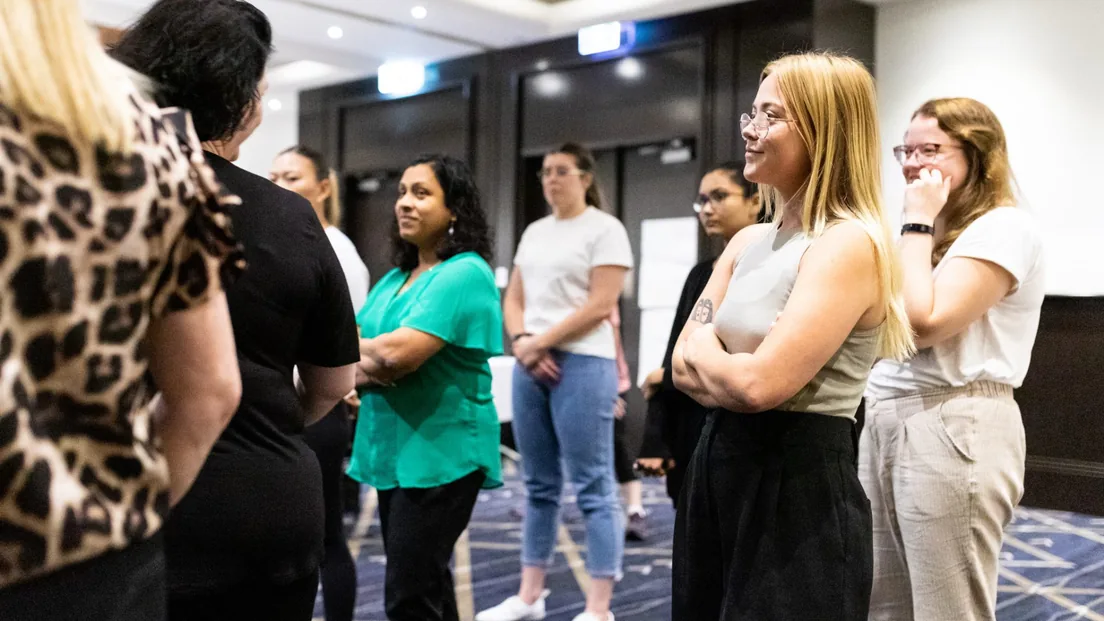 Participants standing in a circle during a domestic and family violence workshop